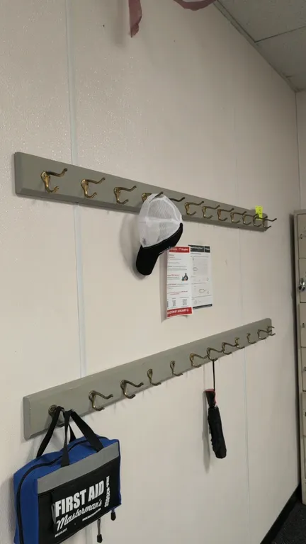 Wall-mounted coat racks. Features painted wood backer boards with brass-tone dual coat hooks. 6'L each. Contents not included.