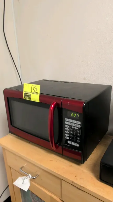 Emerson countertop microwave oven. Features red and black exterior, digital touchpad controls, and interior rotating glass turntable. 19"W. Power: 900