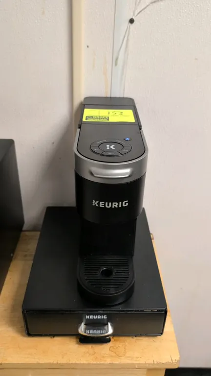 Keurig single-serve K-Cup coffee maker. Features multi-size brew selection controls, removable rear water reservoir, removable drip tray, and includes