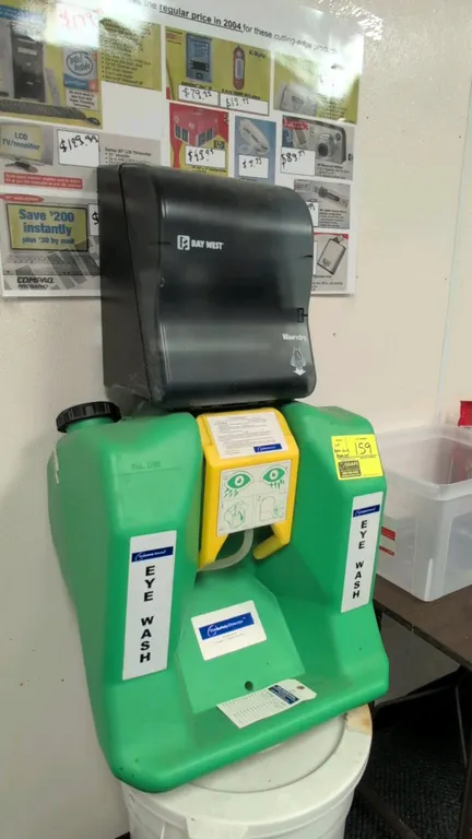 The Safety Director portable eye wash station with Bay West Wave'nDry paper towel dispenser. Features self-contained poly reservoir with drop-down act