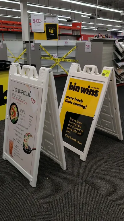 Plasticade Signicade Deluxe poly A-frame sign stands. Features molded white plastic construction, built-in top carrying handles, and sign insert slots