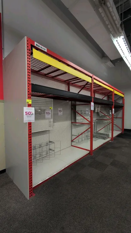 8'L sections of Madix teardrop pallet racking. Features 3" crossbars, wire mesh decking, integrated overhead lighting, roll-down curtains, and pegboar