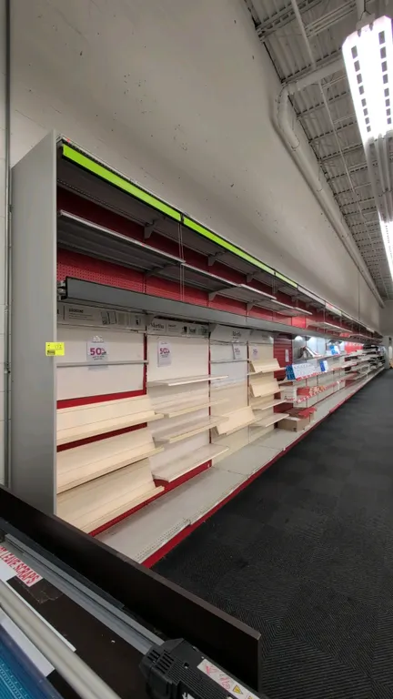 104'L of Madix wall shelving. 120"H uprights with 22" base shelves. Features integrated canopy lighting, pull-down curtains, red pegboard and slatwall