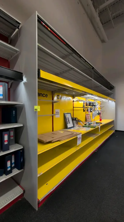 20'L of Madix wall shelving. 120"H with 36" base shelves. Features yellow back panels, overhead canopy lighting, and pull-down roller curtains. Conten