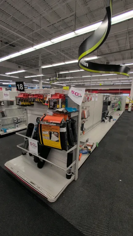 70'L of Madix gondola shelving. Features 60"H uprights, 22" and 18" base shelves, and pegboard backing. Contents not included. Note: Gondola shelving