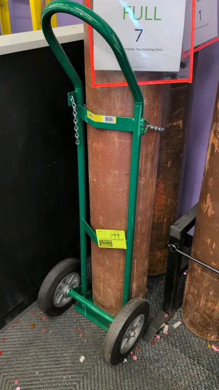 Anthony 6110 cylinder hand truck. Features tubular steel frame, safety securing chain, and continuous loop handle. Mounted on 2 wheels. Gas cylinder n