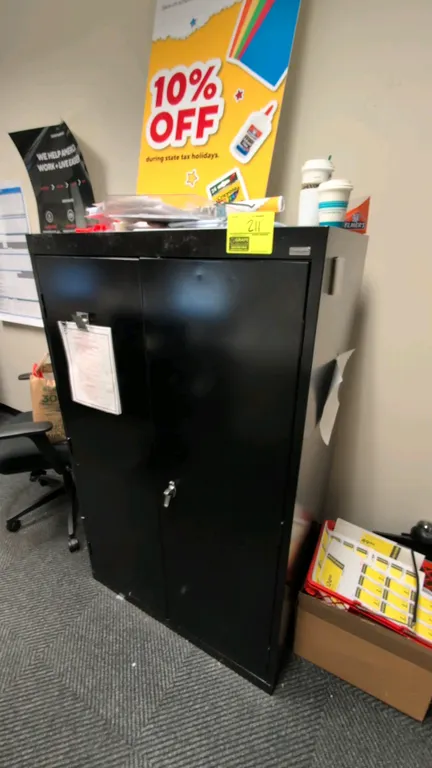 Metal 2-door storage cabinet. Features black finish, dual hinged doors, locking handle, and interior shelving. 3' x 5'H. Contents not included.