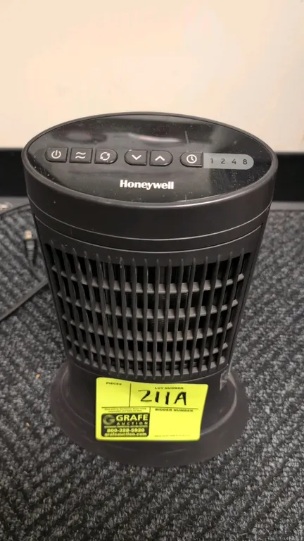 Honeywell HCE311V portable heater. Features top push-button controls with temperature adjustment, oscillation function, and 1 to 8 hour timer settings