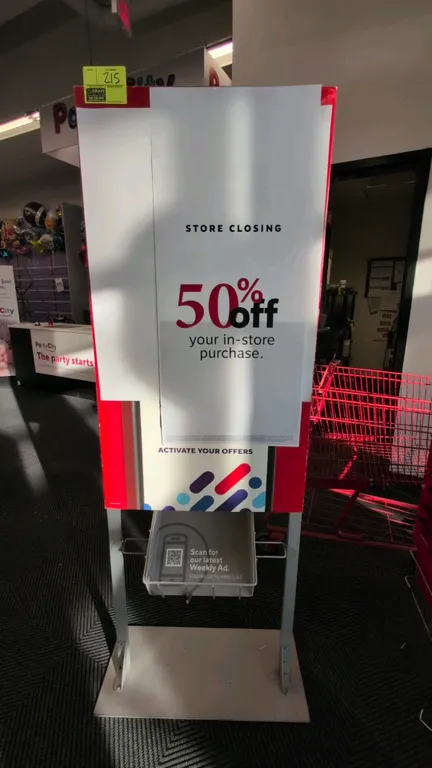 Metal sign stand. Features poster display frame and lower wire literature basket. 28"W x 71"H. Mounted on a flat metal base.