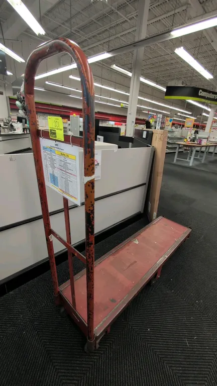 Metal 6-wheel U-boat platform cart. Features steel frame construction, single tall tubular end handle, and solid platform deck. 5'L. Mounted on 6 cast