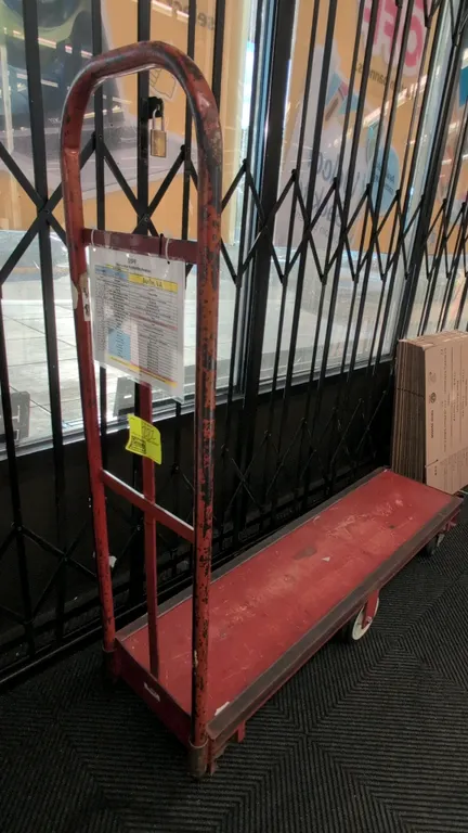 Metal 6-wheel U-boat utility cart. Features red painted steel platform and single tall tubular steel end handle. 5'L. Mounted on 6 wheels with center-