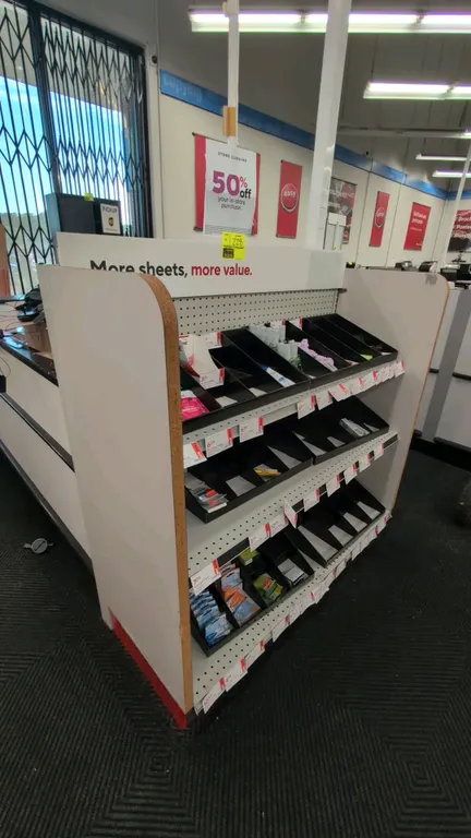 4'L of Madix wall shelving. Features pegboard back panel, adjustable metal shelves with dividers, side end panels, and 18" base shelf. 48"H. Contents