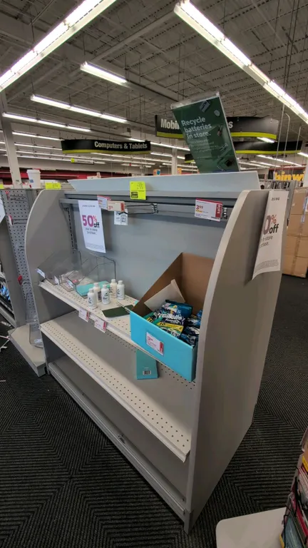 51" 2-sided laminate merchandise display rack. Features curved gray laminate side panels, adjustable metal shelves, display hang rail, and wire hangin