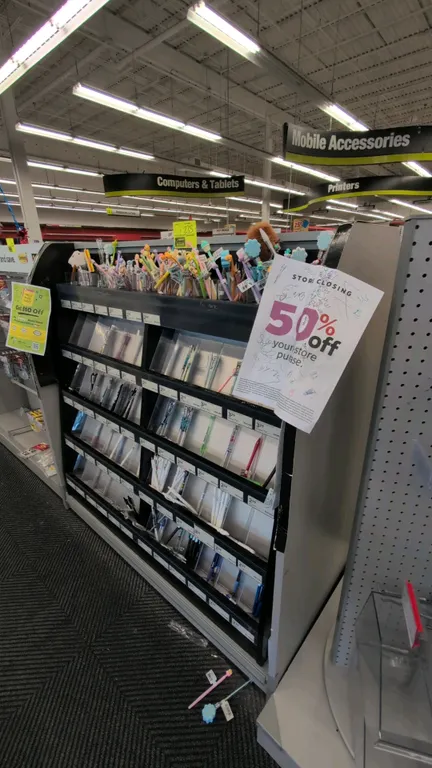 Two-sided laminate merchandise display rack. 51"L. Features gray laminate curved end panels, multi-tier stationery display inserts on one side, and cl