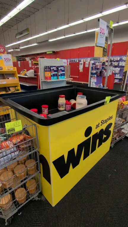 Poly dump merchandise rack. Features a black polyethylene tub top and wrapped display base. 53"L. Contents not included.