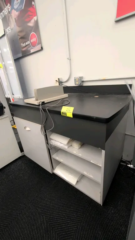 Laminate countertop work cabinet. Features a black laminate top with integrated backsplash, single-door lower storage cabinet, and open adjustable she