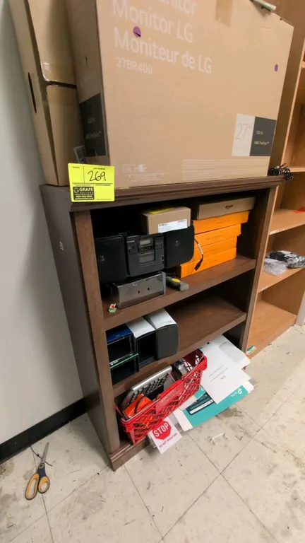 Wood 3-shelf bookcase. Features a dark wood laminate finish and decorative top molding. 36"W x 44"H. Contents not included.