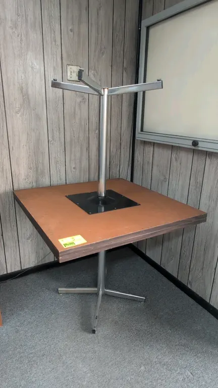 Laminate dining tables. Features square tops with a woodgrain finish. 3' x 3'. Mounted on metal 4-prong pedestal bases with leveling glides.