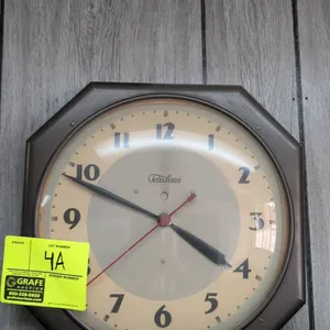 Telechron 13" analog wall clock. Features an octagonal brown casing, convex glass crystal, Arabic numeral dial, and a red sweep second hand.