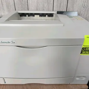 Hewlett Packard LaserJet 5M laser printer. Model C3917A. Features top output tray, front fold-out multi-purpose tray, and push-button control panel. E
