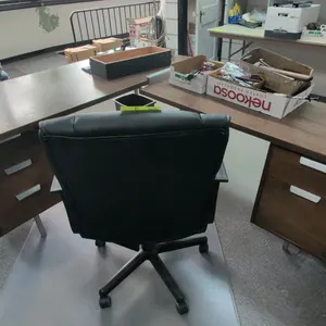 Laminate wood L-shaped desk with faux leather office chair. Desk features dual under-desk drawer pedestals with modern pulls and metal legs. Chair fea