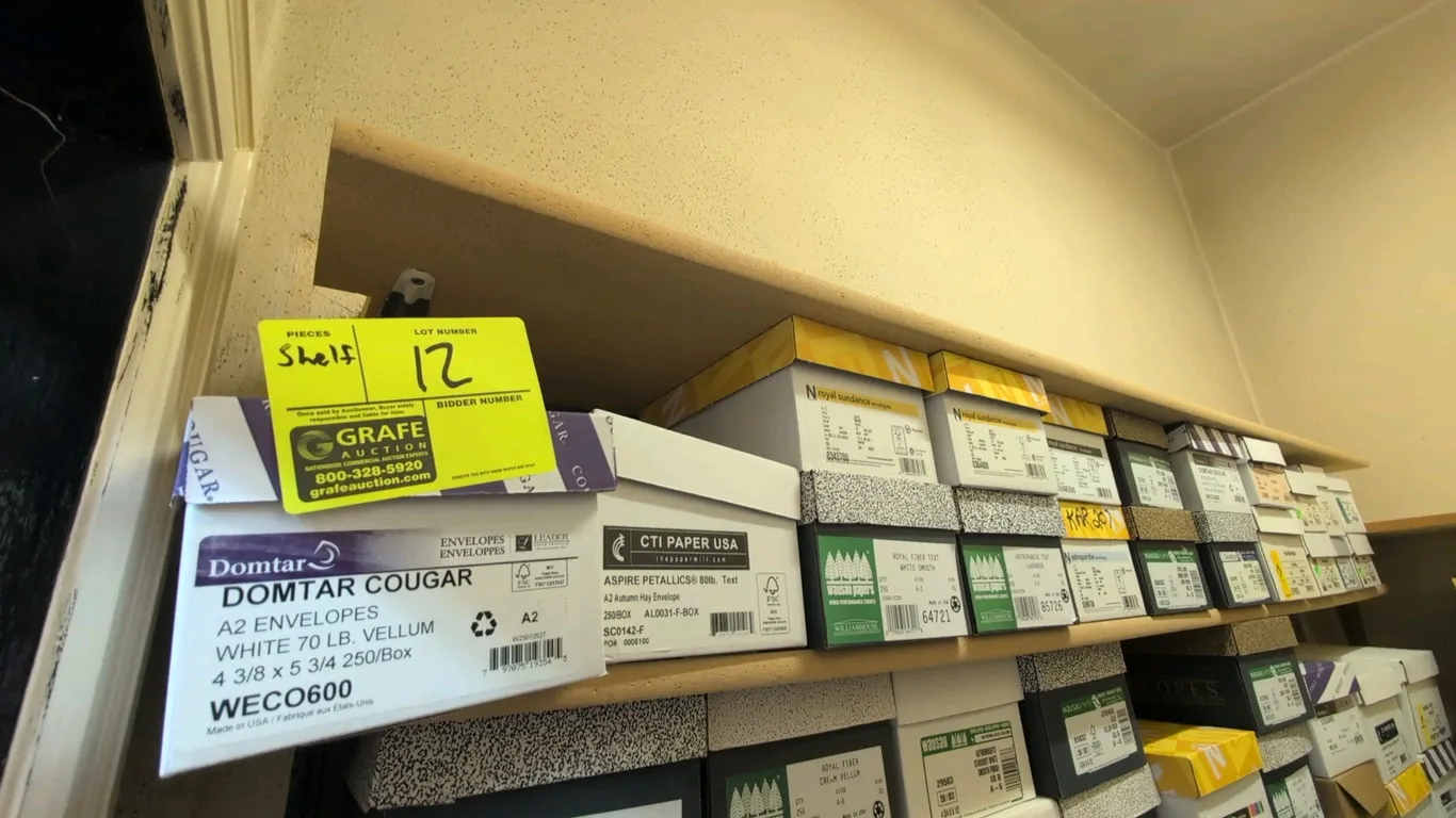 Assorted specialty envelopes and announcement cards on shelf. Includes various brands such as Domtar, Neenah Paper, Wausau, and Leader. Features assor
