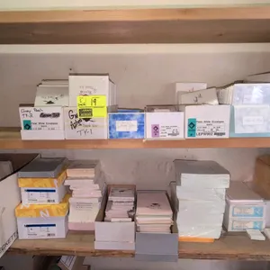 Assorted stationery and paper products lot. Includes envelopes, thank you notes, graduation invitations, and specialty paper across (2) shelves. Featu