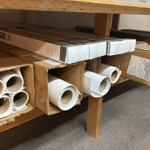 Assorted plotter paper rolls. Compatible with HP DesignJet Z6 Pro production printers. Includes an assortment of boxed and loose media rolls. Shelving