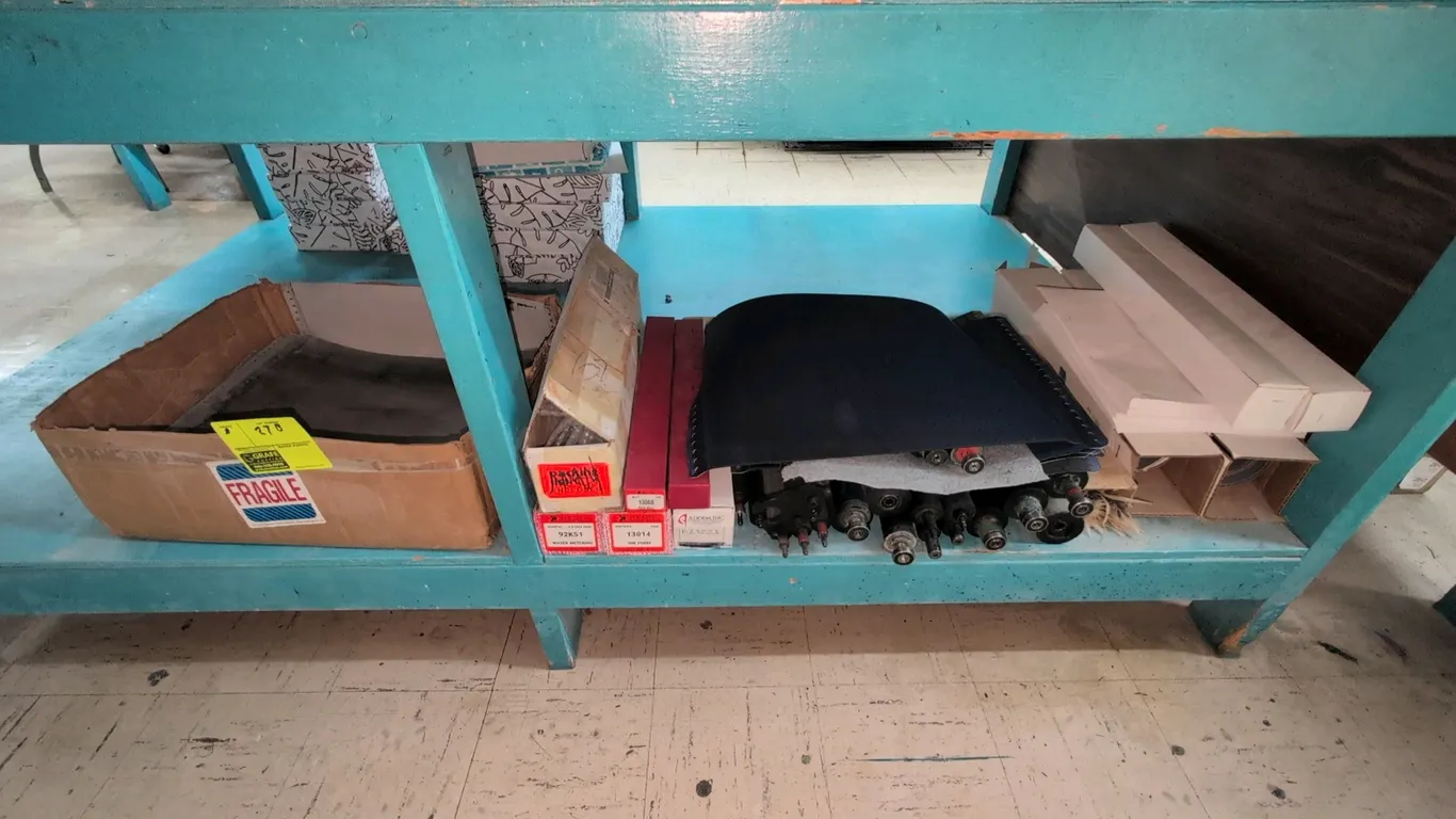 Printing press parts and supplies assortment. Includes offset printing plates, assorted press rollers, replacement feed and ink rolls in packaging, bl