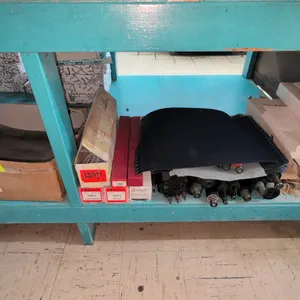 Printing press parts and supplies assortment. Includes offset printing plates, assorted press rollers, replacement feed and ink rolls in packaging, bl