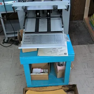 Baumfolder 714XE Ultrafold friction feed tabletop paper folding machine. Features adjustable fold plates, friction feed table, and delivery tray. Incl