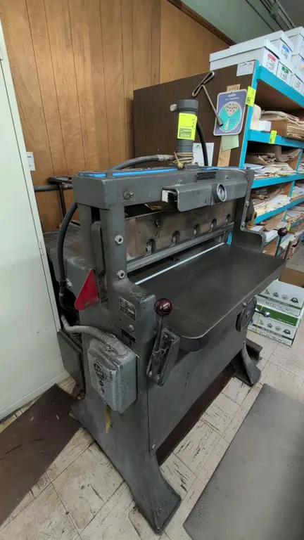 Challenge Style F Size 305 paper cutter. Features hydraulic clamp and blade operation, 30.5" cutting width, cast iron bed with adjustable backgauge, a