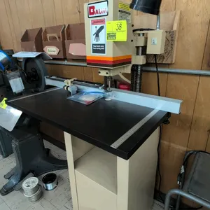 Baumfolder ND1F single-hole paper drill. Features foot pedal operation, adjustable backgauge with stops, work table, and attached work light. S/N: 86-