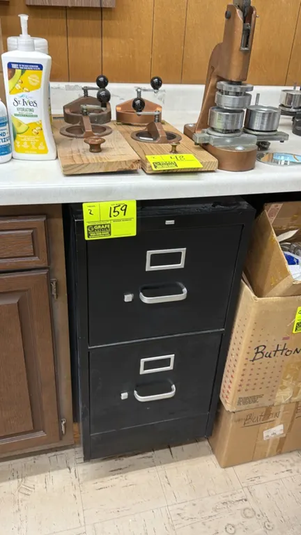 Metal 2-drawer vertical filing cabinets. Features black finish, 2 drawers with silver-tone pull handles, integrated label holders, and thumb latches.