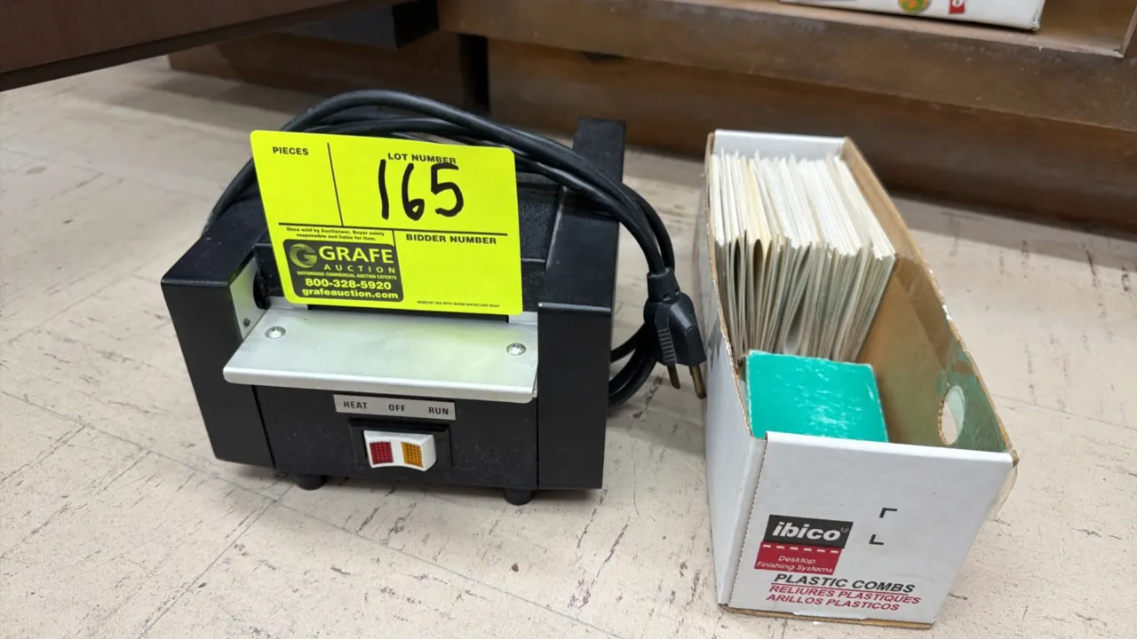 Model 5000 tabletop ID and name tag laminator. Features heat/run control switches and feed tray. Includes a box of name tag laminating pouches. Electr