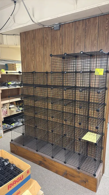 Modular metal wire grid panel shelving. Features black coated wire grid panels with plastic joiner connectors. Fully customizable configuration. Inclu