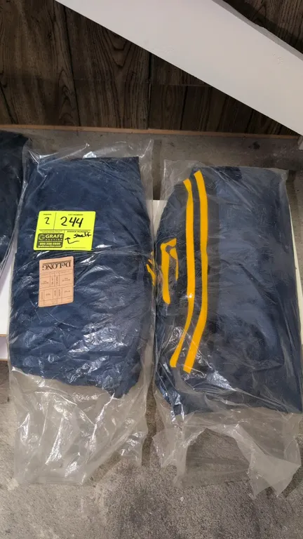 DeLONG 656 youth nylon letterman jackets. Features blank navy blue shell with yellow striped ribbed knit collar, cuffs, and waistband, snap button fro