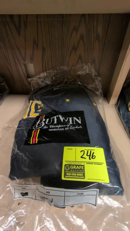 Butwin 1301N-000 nylon letterman jacket. Features navy blue nylon shell with yellow accents, snap-button front closure, yellow quilted interior lining