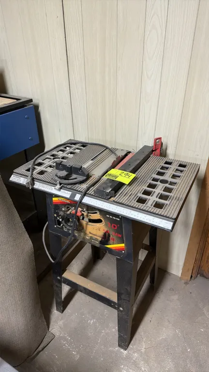 1985 Menards 240-2402 10" table saw. Features a rip fence, miter gauge, and bevel adjustment. Motor: 1.5 HP. Electrical: 115V, 60 Hz, 1-Phase, 9.5A. M