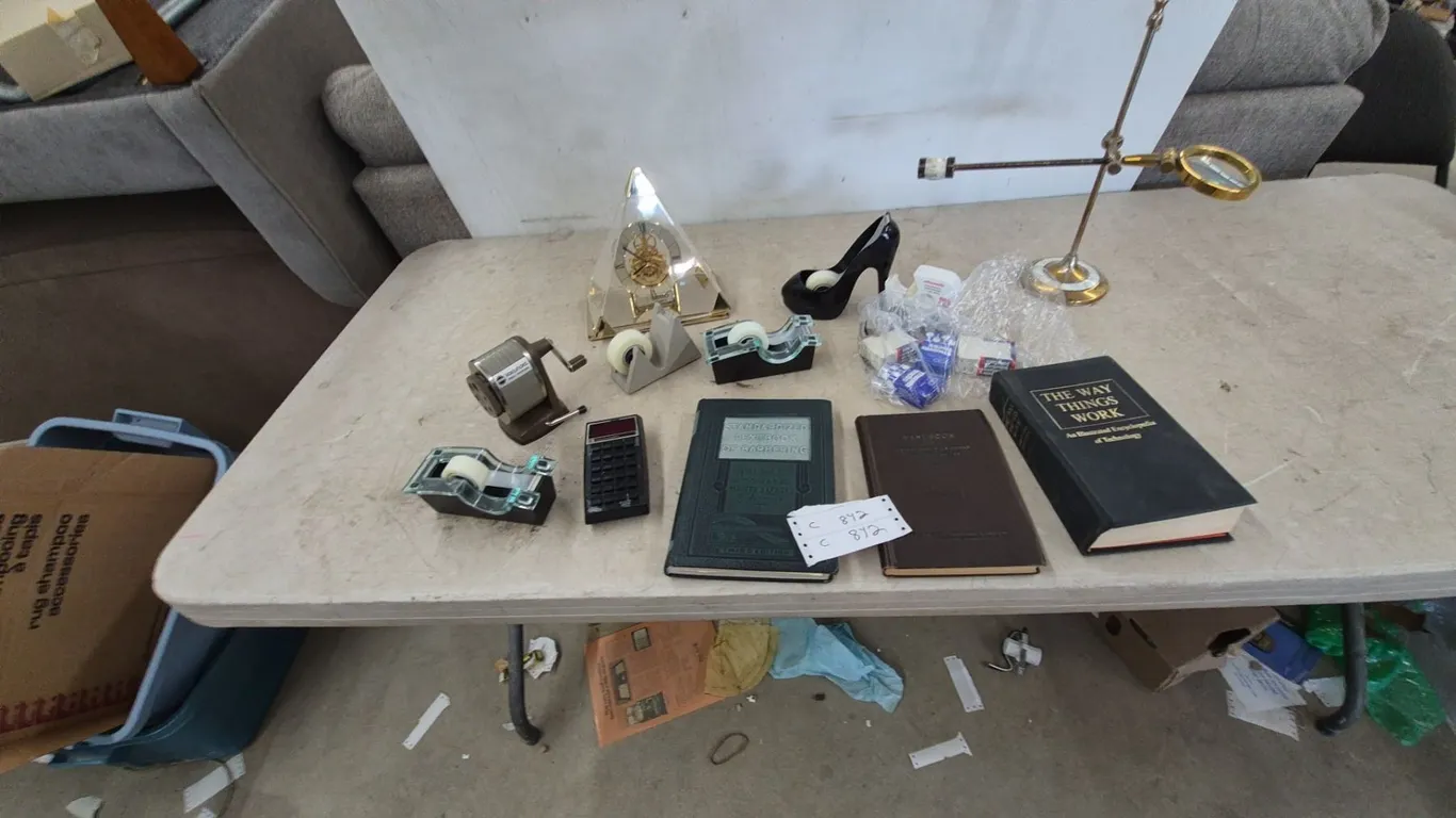 Adjustable Magnifying Glass, Pyramid Clock, High Heel Shoe, 3 Tape Dispensers, Calculator, 3 Books