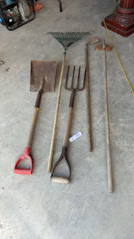 Scoop Shovel, Four-Tine Digging Fork, Leaf Rake, and Two Hoes with Wooden Handles