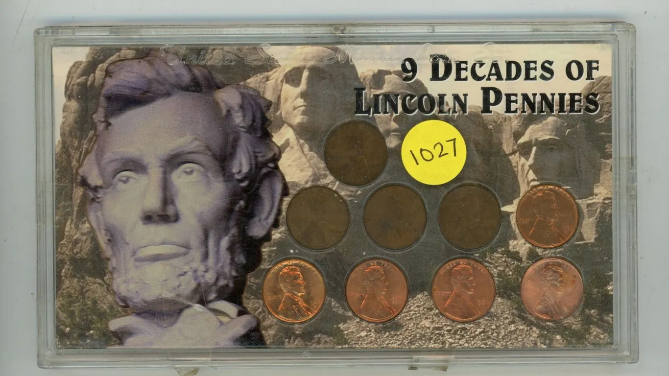 9 Decades of Lincoln Pennies. One from each decade. Housed in a hard plastic holder.