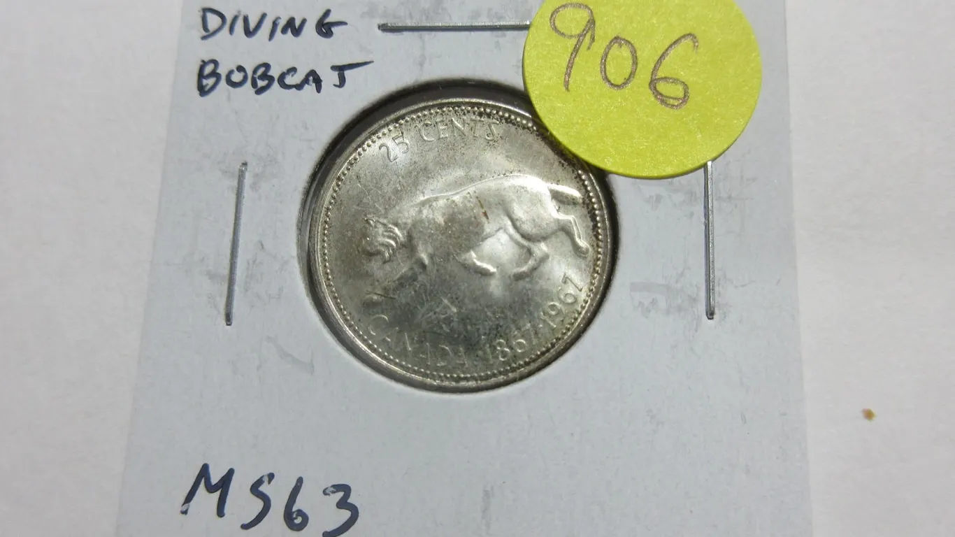 1967 Diving Bobcat Silver 25 Cents. There is a Die Rotation so that it appears that the Bobcat is Di