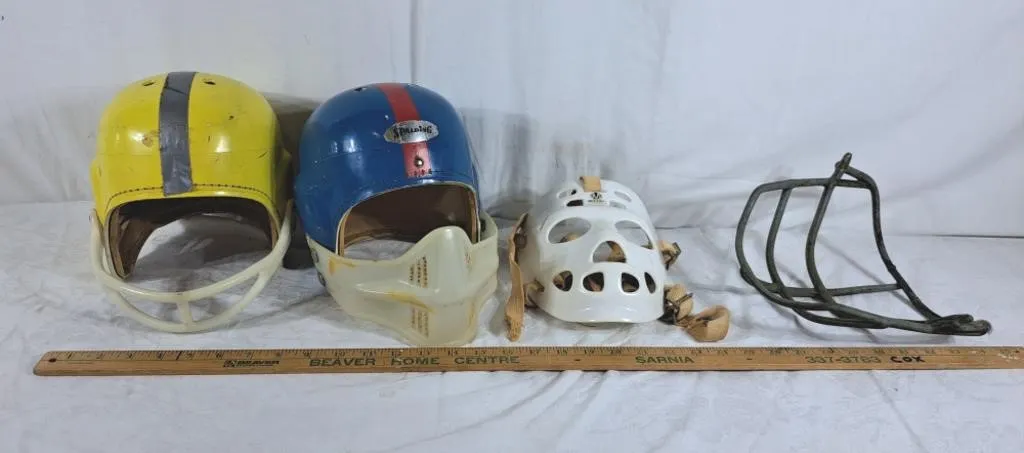 Two vintage football helmets with attachments and