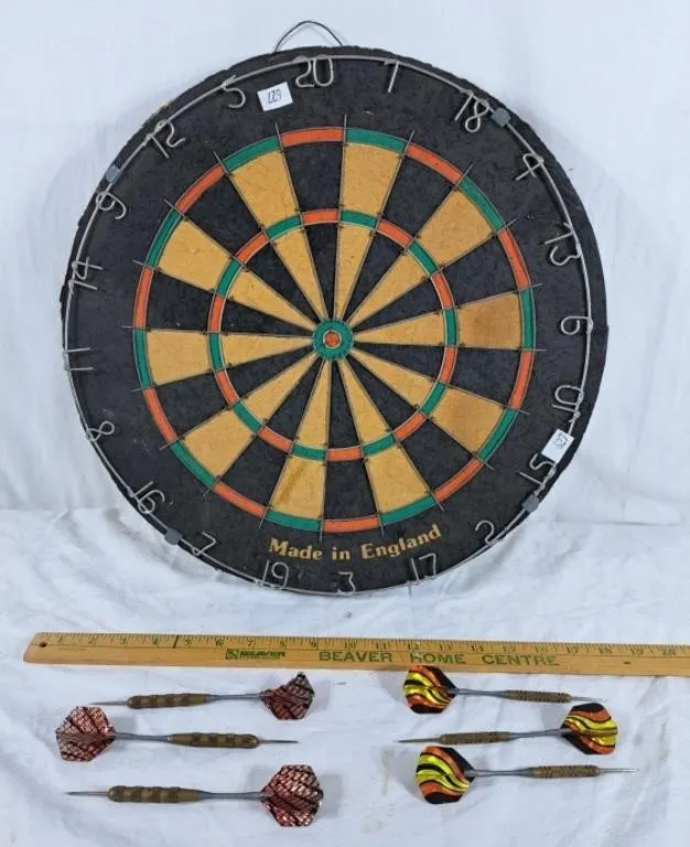 Dart board and two sets of darts.