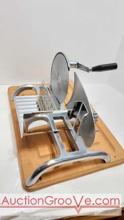 Stainless Steel Adjustable Meat Slicer on cutting board with storage case. BC