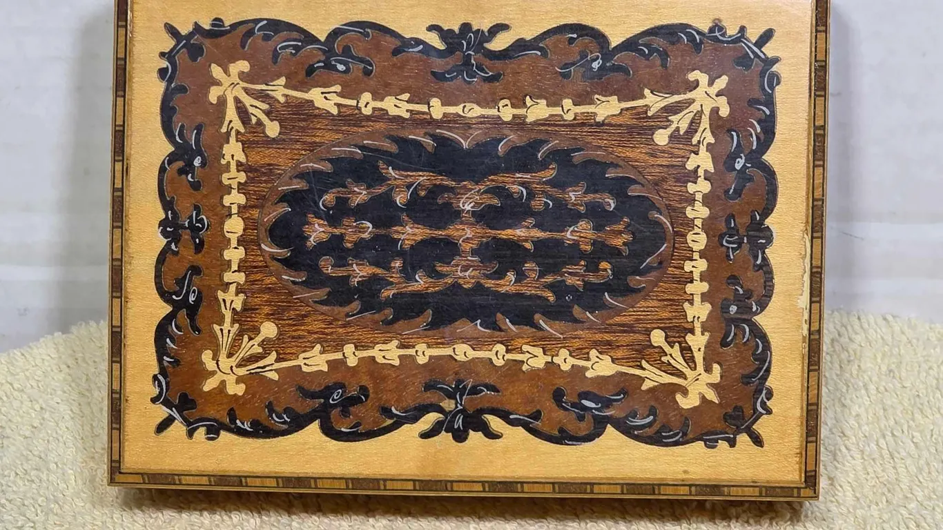 Reuge. Italian Music Box. Plays Romeo and Juilette with Swiss Movement. Box top needs to be reattached to the hinge. 6 x 4.5 x 2. LR