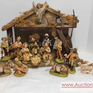 A Vintage 21 piece Italian rustic Nativity Set with hand-painted composite figures, and a detailed moss-adorned wooden stable. The set includes the Ho