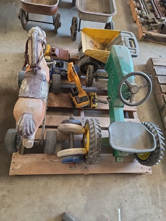 Pedal tractor, antique rocking horse, tonka trucks and toys
