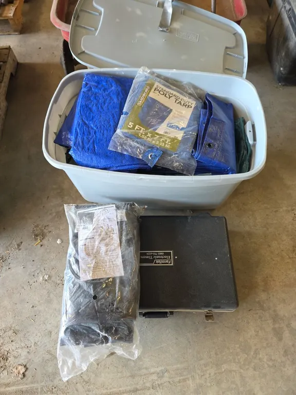 Farm tech electronic timers, qty of tarps in tote and a unused luggage cover